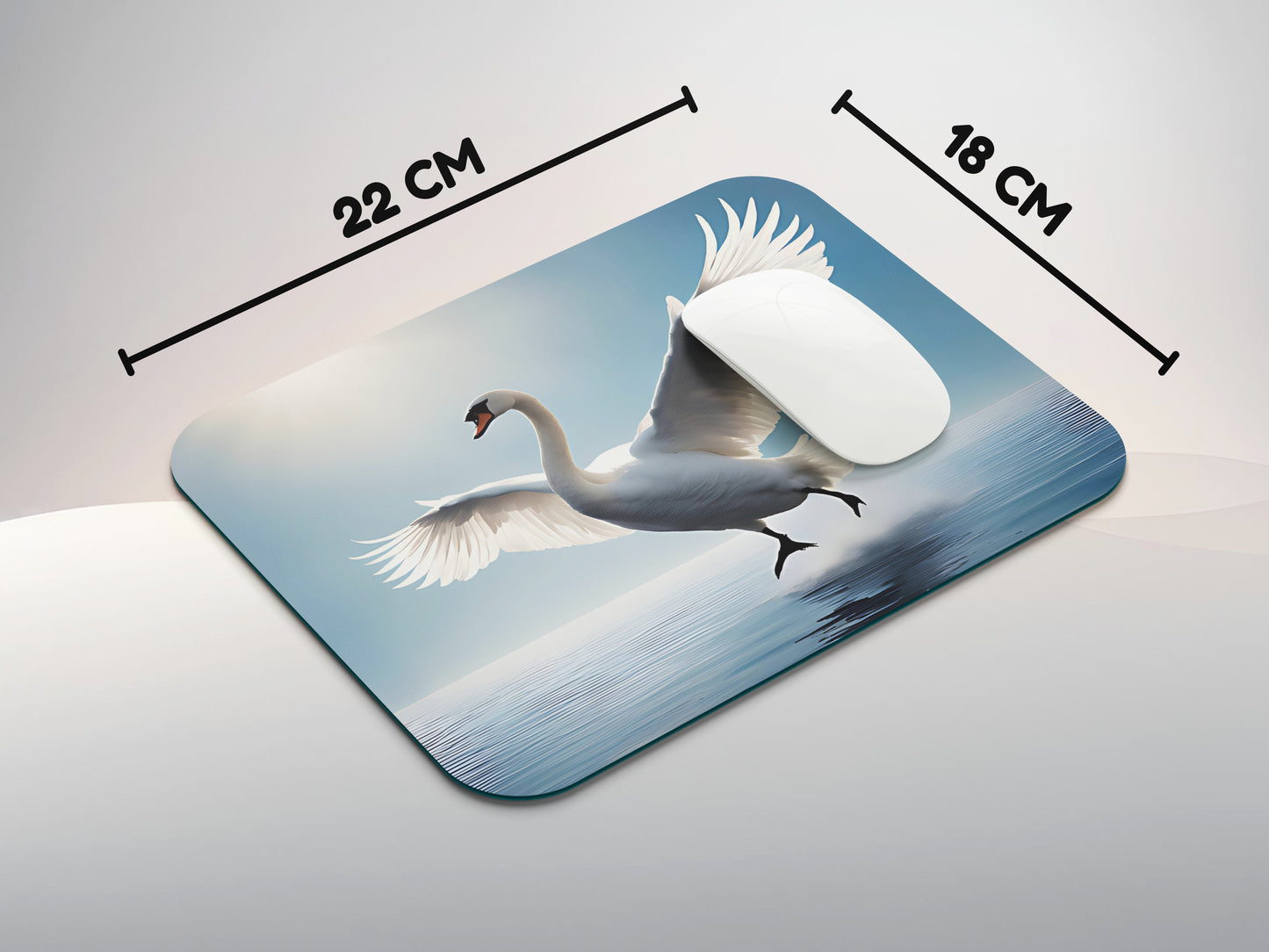 Swan in mid-flight, with its wings fully extended against a clear blue skymousepad mockup style 3